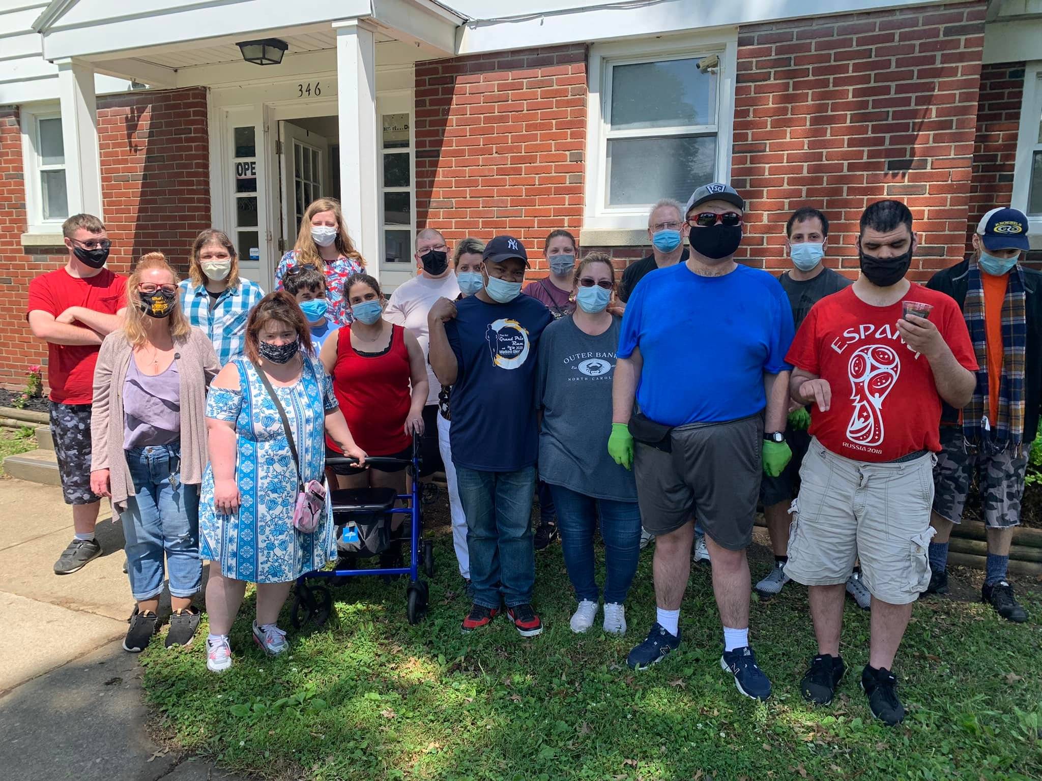 Community members planting flowers at His Haven in Elmira NY